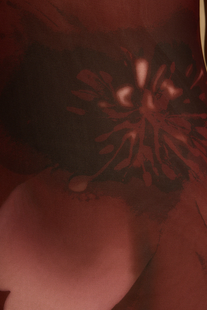 Close-up of mulberry floral print on sheer stretch mesh maxi dress fabric.