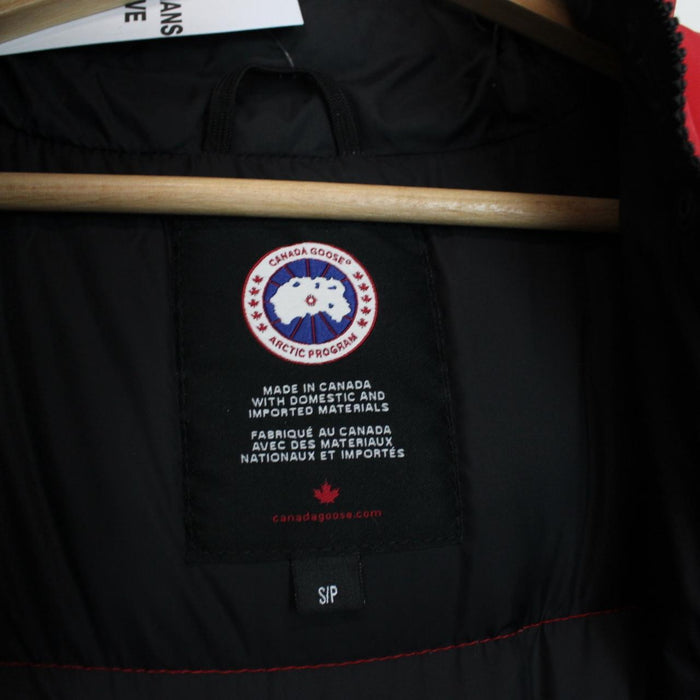 Canada Goose red down gilet with logo patch and zippered pockets.