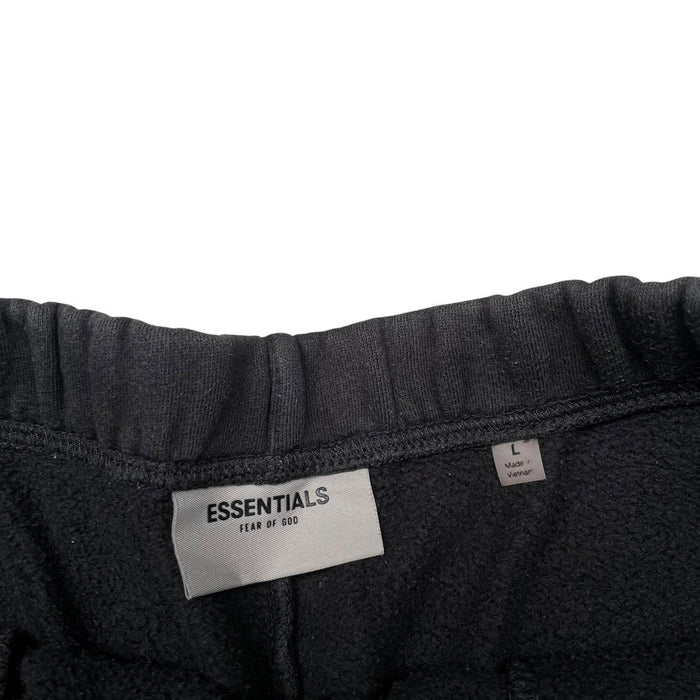 Essentials black jogger shorts cotton material with faded detailing and logo.