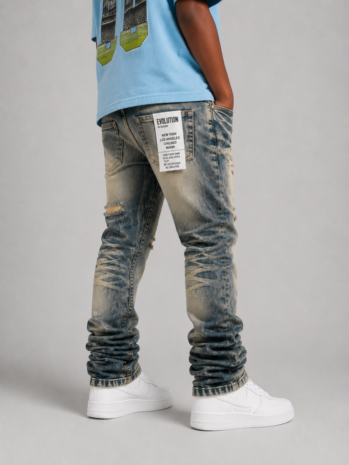 Light wash Evolution Kids Relaxed Straight denim jeans for kids, showing a close-up of the light tint fabric and classic denim stitching.