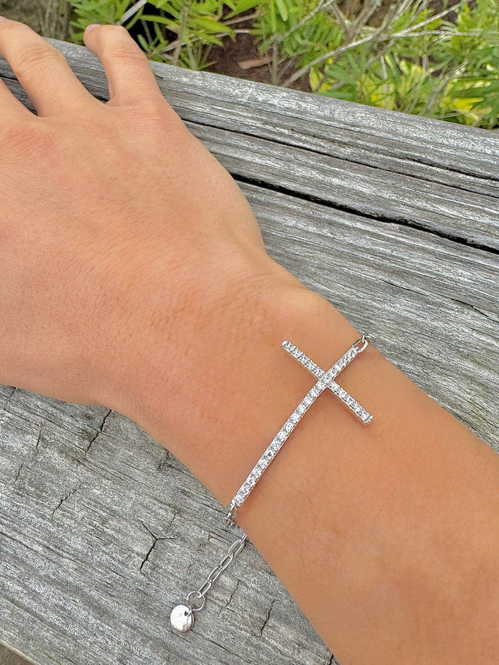Silver bracelet on a wrist with a natural background