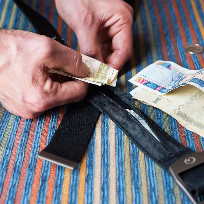 Person folding emergency money when placing it in their Lifeventure tarvel money belt