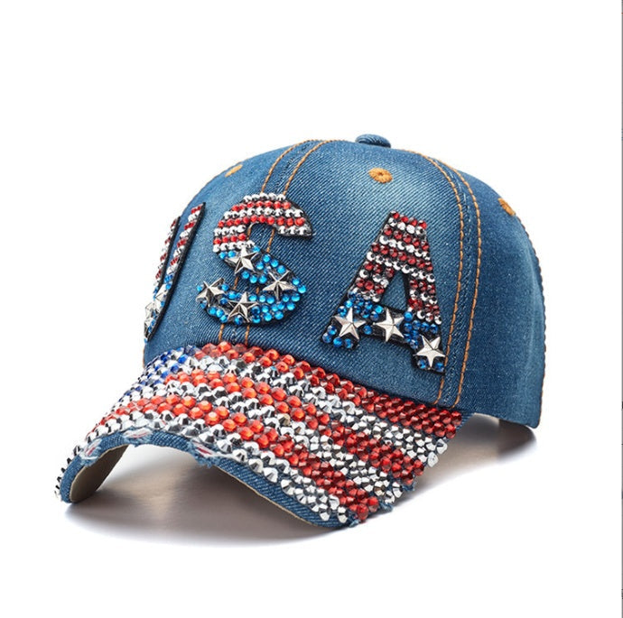 Navy bling baseball cap with USA fan styling, washed denim texture, red, white and blue crystals and an adjustable strap fit.