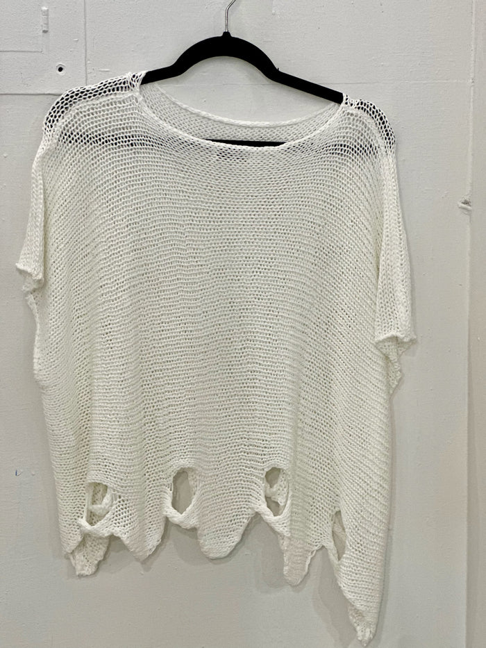 Detail of Vanda white sweater scalloped hem with circular twist cut-outs