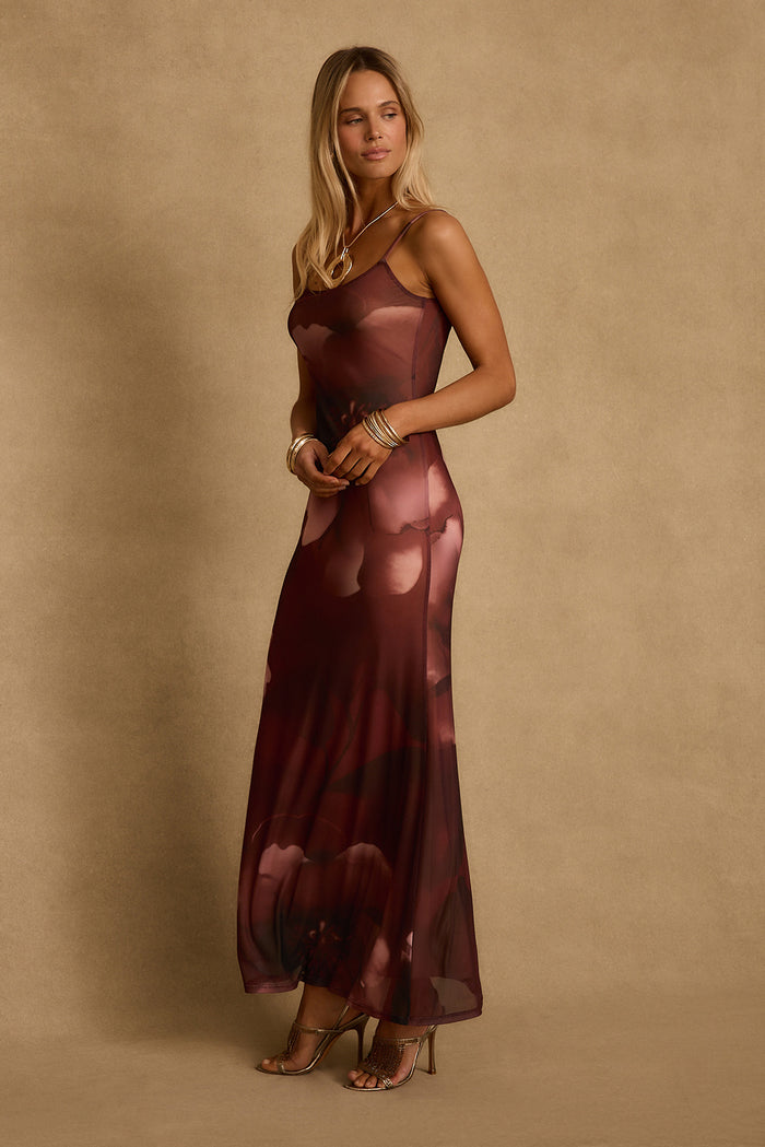 Side view of the Amora mulberry floral mesh maxi dress styled with gold heels and bangles.
