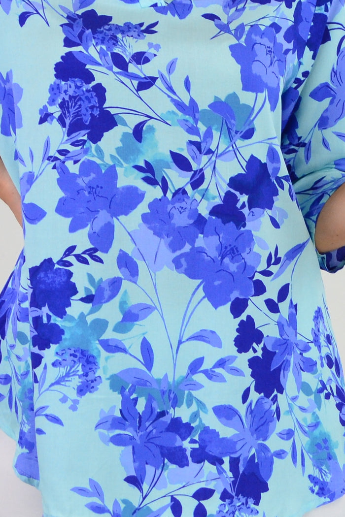 Blue floral tunic top from I Love Tunics with a vibrant pop of color and a relaxed fit, featuring a floral pattern and lightweight fabric.