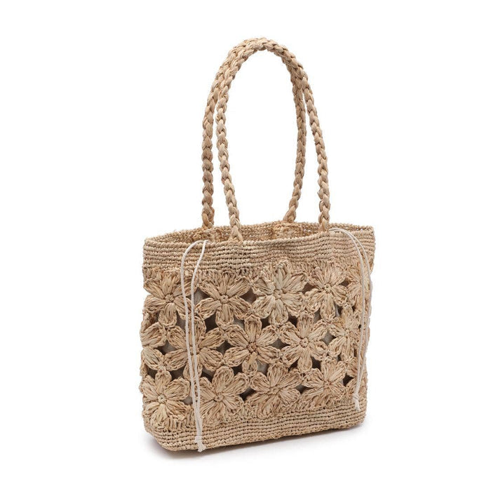 Natural woven tote bag featuring an open floral crochet design, braided shoulder straps, and a structured rectangular silhouette. Crafted in a natural raffia-style material with intricate flower detailing and a lightweight, beach-inspired look.