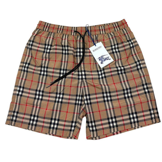 Burberry beige swim shorts featuring Nova Check pattern and nylon material.