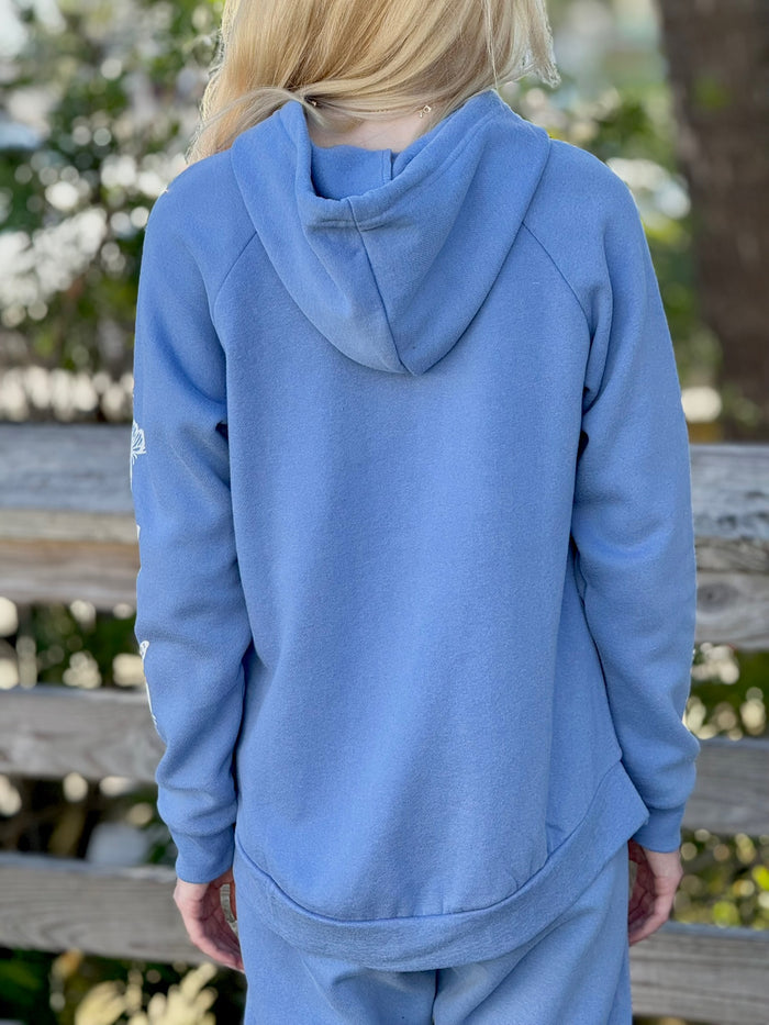 Women’s butterfly pullover hoodie with chest butterfly graphic, butterfly sleeve design, drawstring hood and ribbed trim at Ardor Boutique.