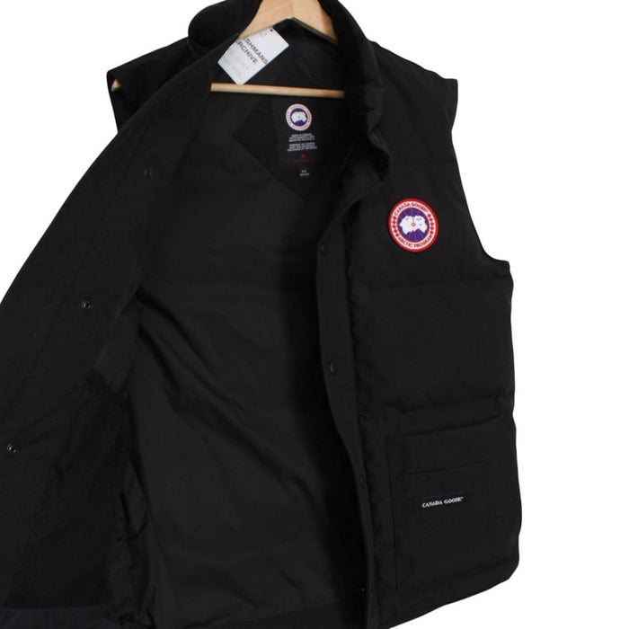 Canada Goose black down gilet with logo patch and zippered pockets.