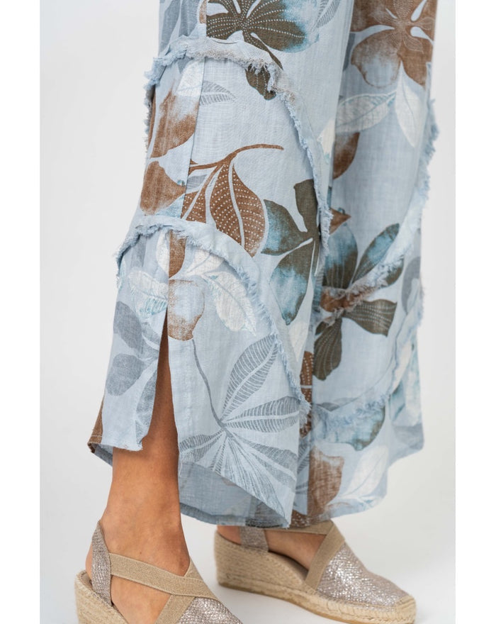 Catherine pants in light blue. Close up detail shot of leg slit and frayed ruffle detail