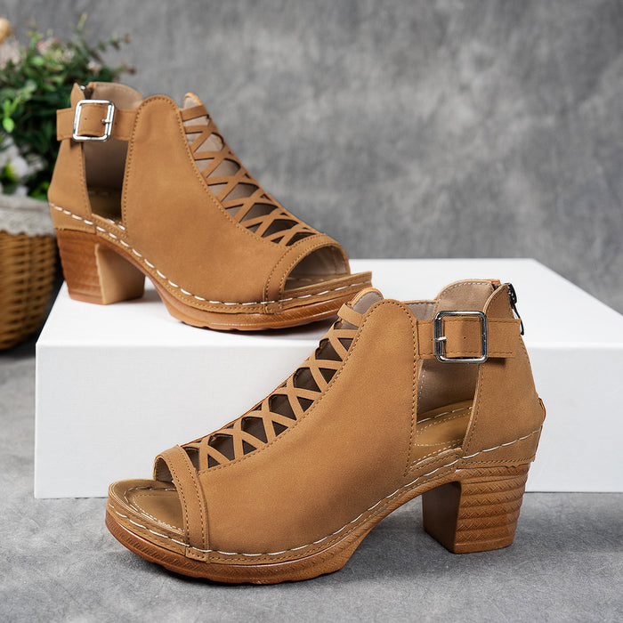 Tan open-toe sandals with block heels on a gray surface.