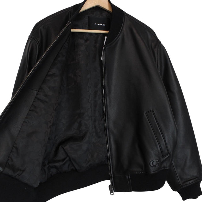 Coach black lamb leather bomber jacket with full zip and brand logo.