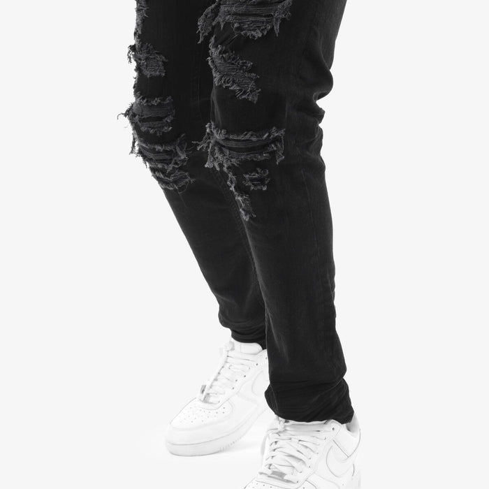 Copper Rivet Rip & Repair black denim jeans showing distressed details and rivet accents on the fabric.
