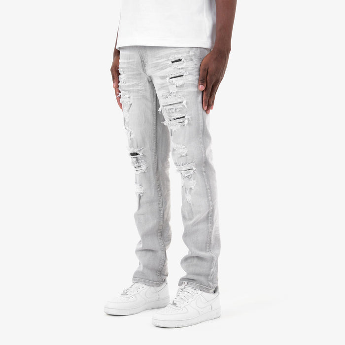 Copper Rivet Rip & Repair Grey denim jeans with distressed detailing and copper rivet accents.