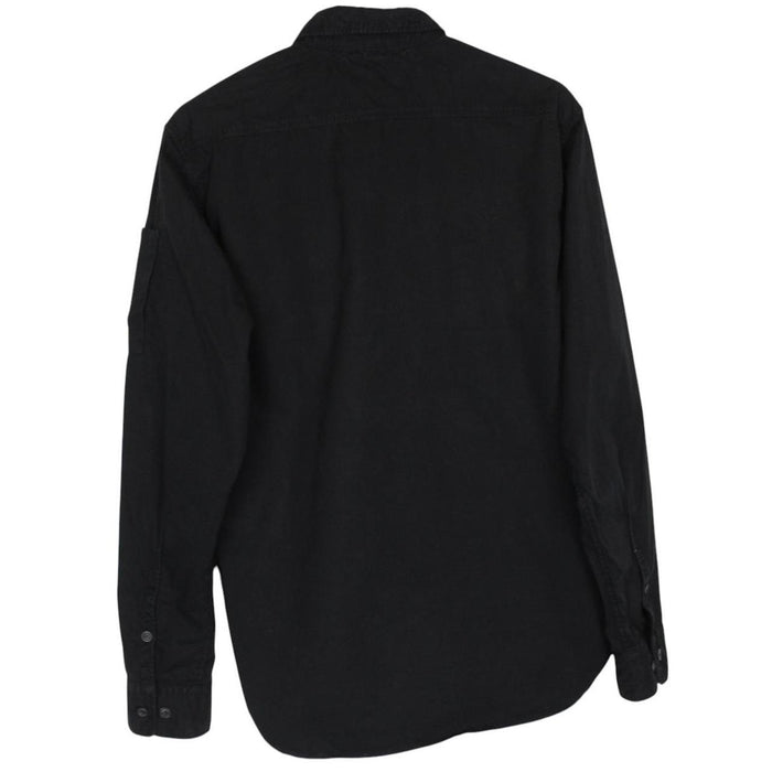 CP Company black button-up jacket with lens detail and cotton material.