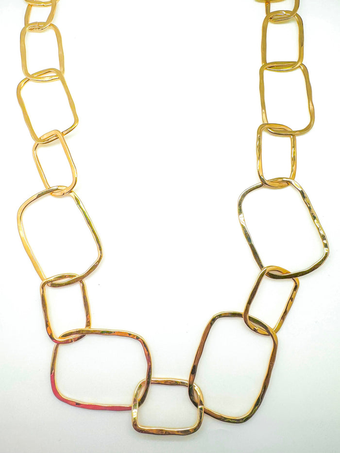 Gold chain necklace on a white background