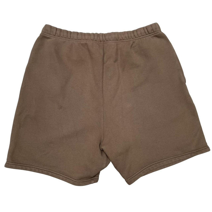 Essentials brown jogger shorts with logo detail and soft cotton material.