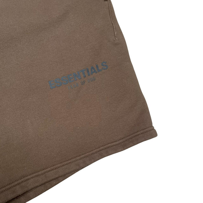 Essentials brown jogger shorts with logo detail and soft cotton material.