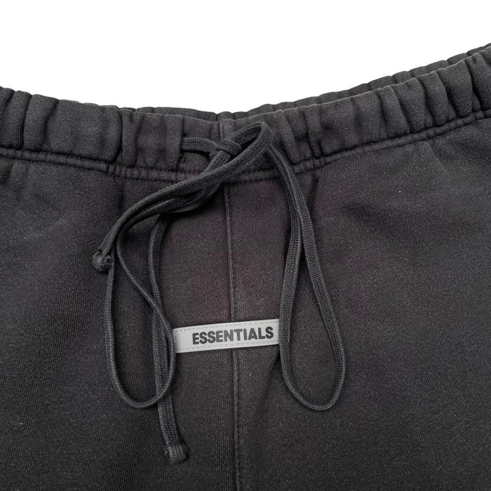 Essentials black jogger shorts cotton material with faded detailing and logo.