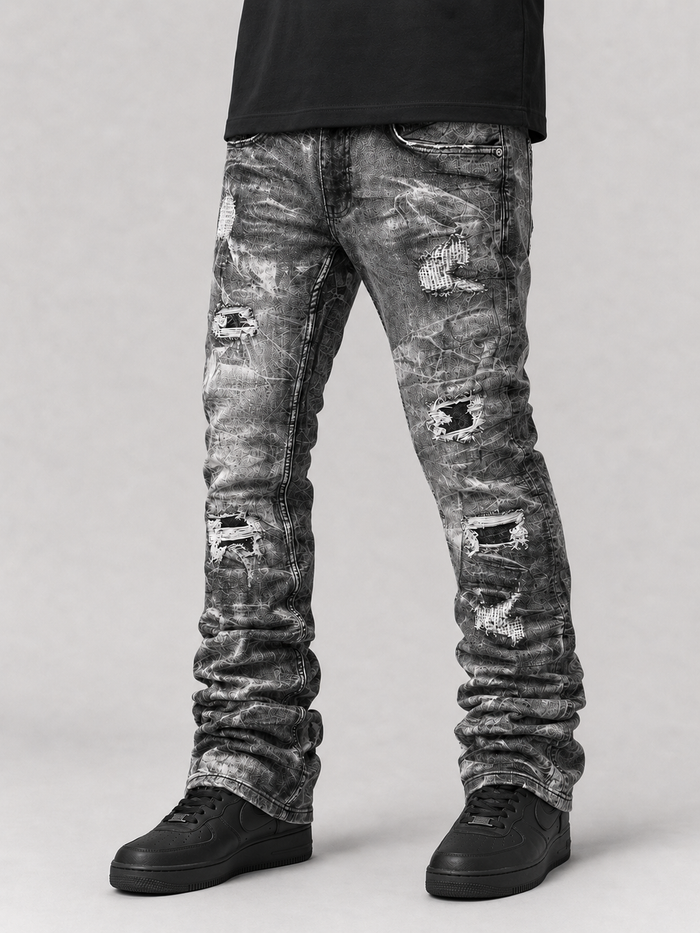 Evolution 'Explosion' stacked denim jeans in washed black with a distressed, layered design and metal button details.