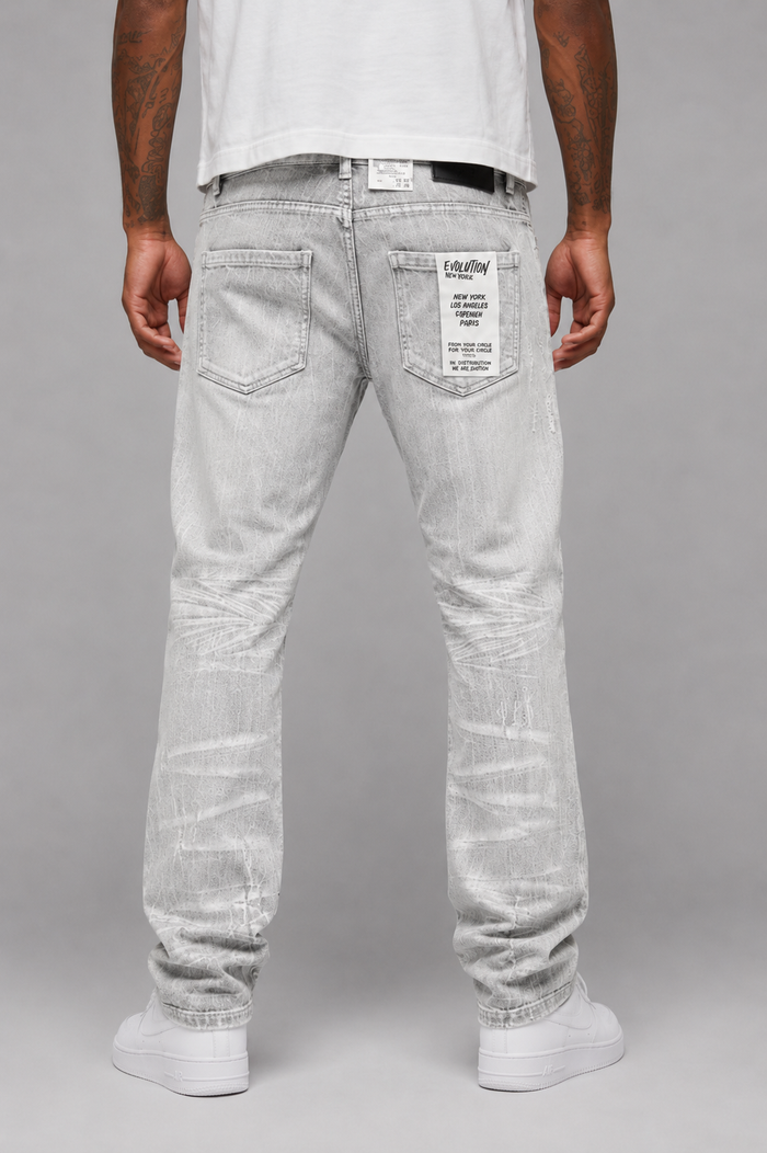 Evolution Faded Relaxed Straight Grey Denim jeans showing the distressed fabric, relaxed fit, and classic five-pocket design.