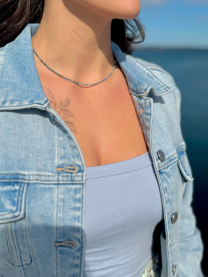 Model wearing Farah Apatite Stainless Steel Necklace, a minimal apatite beaded necklace in sea-toned blues with gold accents.
