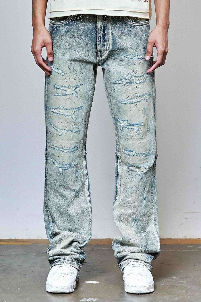 First Row allover rhinestone flare fit denim jeans in medium stone tint, showcasing sparkling embellishments and stylish fit.