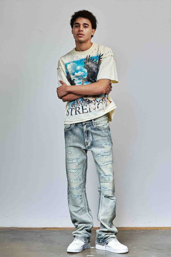 First Row allover rhinestone flare fit denim jeans in medium stone tint, showing detailed rhinestone embellishments and classic denim fit.