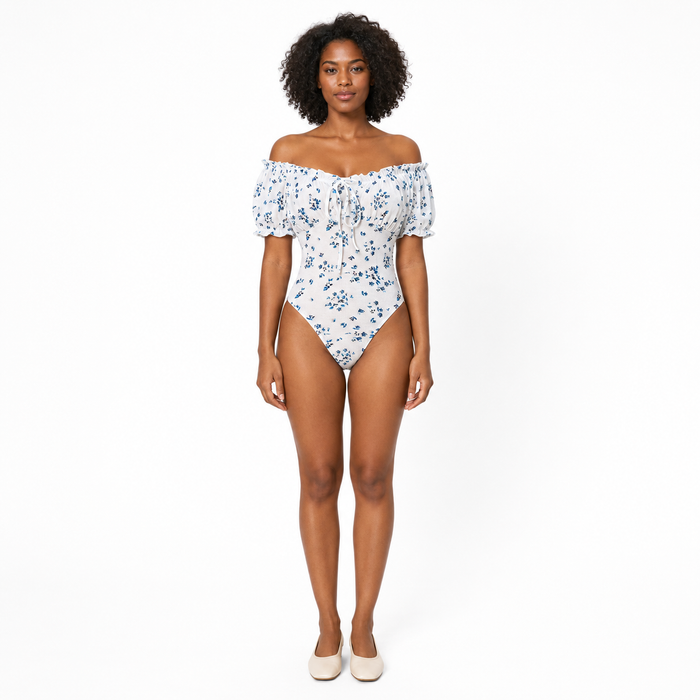 Floral bodysuit for women with puff sleeves and square neckline, shown from the front on a professional studio model.