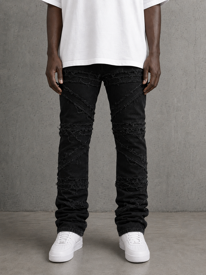 FWRD Crossover Stacked Denim in Jet Black, close-up of the high-waisted denim jeans with layered cuffed hems.
