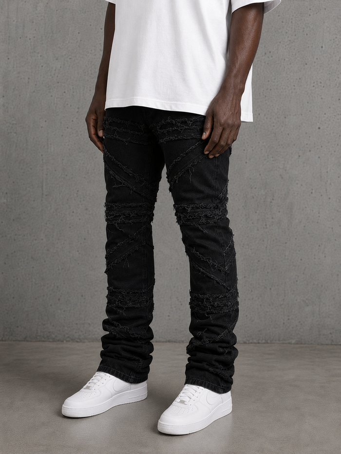 FWRD Crossover Stacked Denim jeans in Jet Black showing their fitted design and stacked leg style.