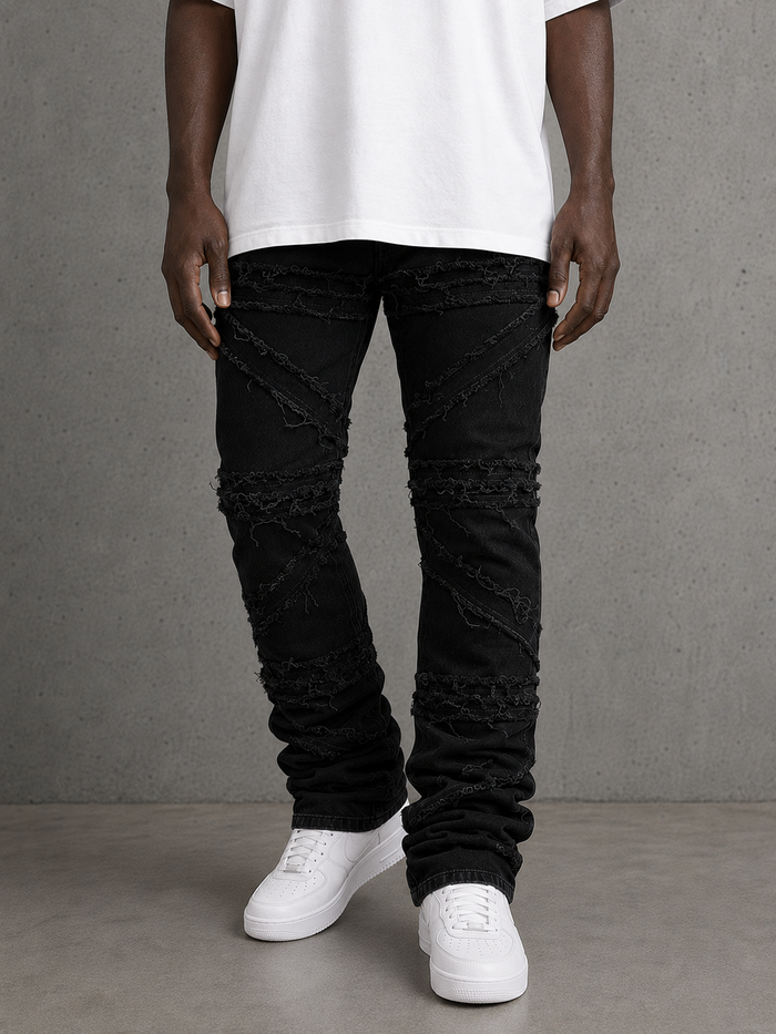 FWRD Crossover Stacked Denim jeans in Jet Black, showing the front view with layered denim design and brand logo detail.