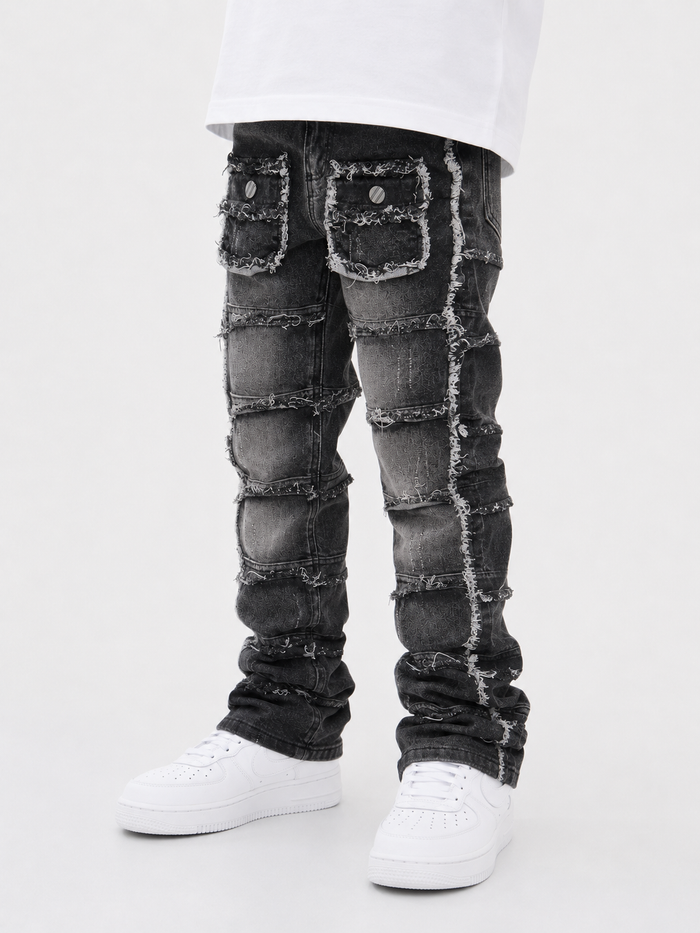 FWRD KIDS Cargo Stacked Denim jeans in washed black, featuring a relaxed fit and stacked design, displayed on a hanger.
