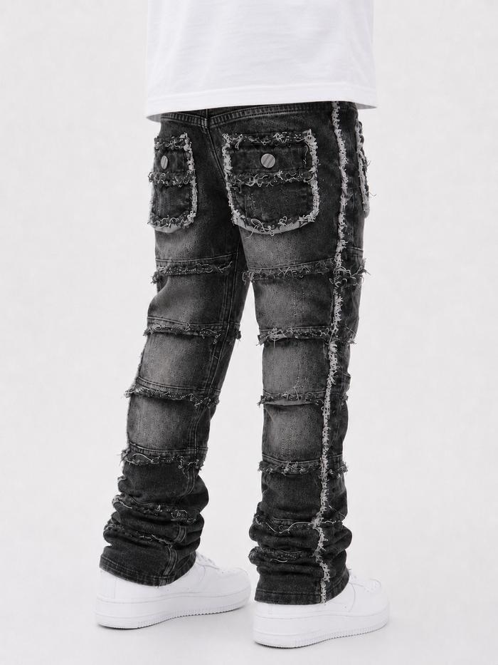 FWRD Kids stacked denim cargo pants in washed black, displayed on a hanger with a casual, relaxed fit.