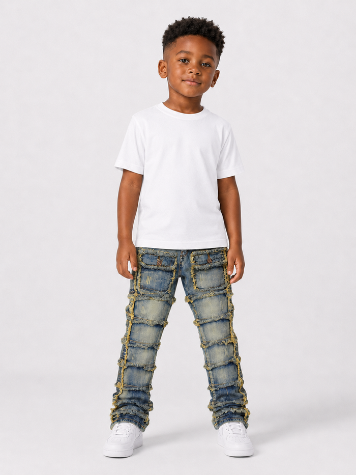 FWRD Kids patchwork stacked denim jeans in light tint, featuring multicolored patchwork design and classic denim texture.