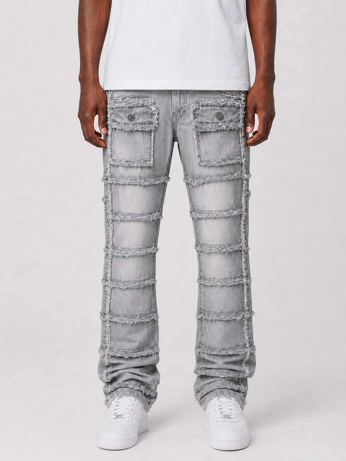 FWRD Patchwork True Stacked Denim jeans in grey showing front view with patchwork design and stacked leg details.