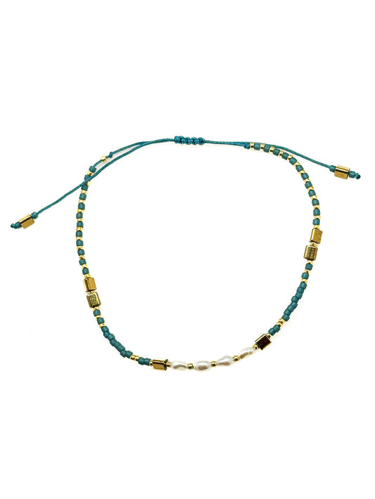 Gina Teal Pull Bracelet with teal beads, freshwater pearl center detail, gold-tone accents, and adjustable pull closure