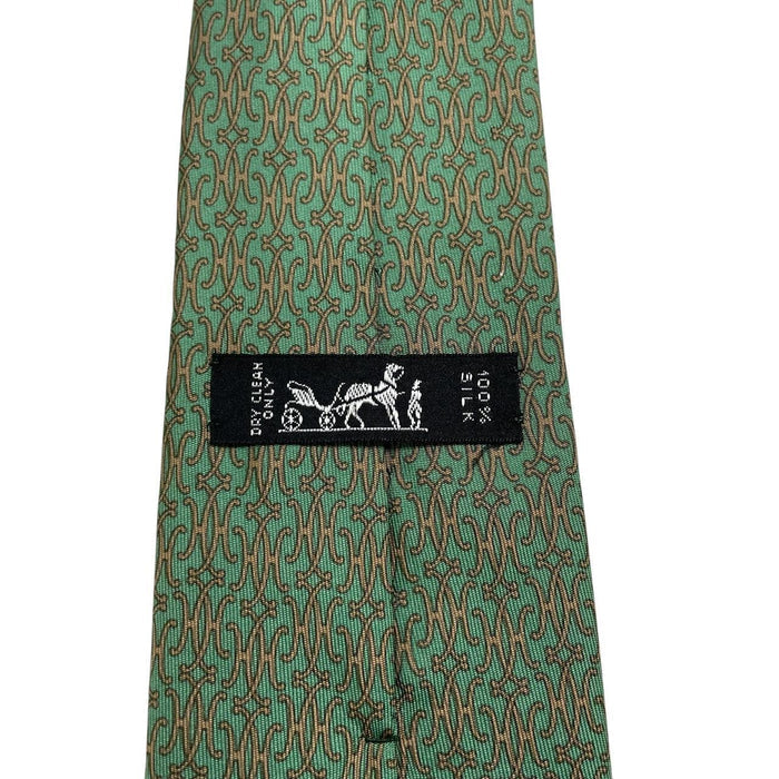 Hermes green silk tie with subtle sheen and logo detailing.