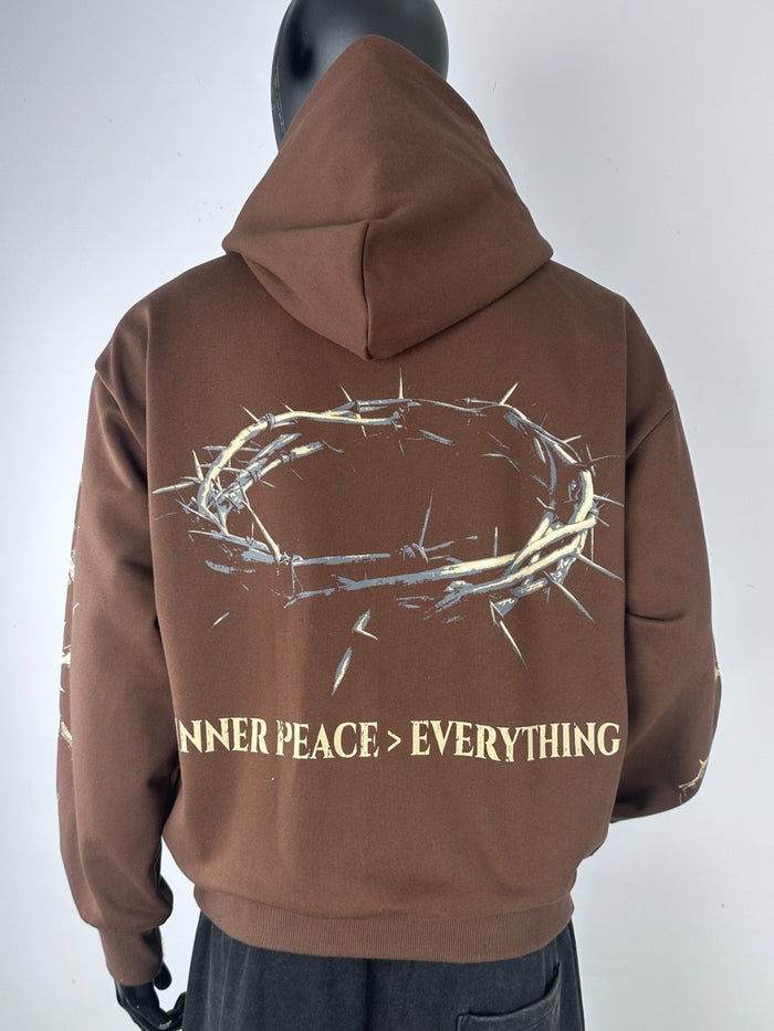 Inner Peace brown hoodie with 'IP Over Everything' slogan, featuring a comfortable pullover design and hooded style.