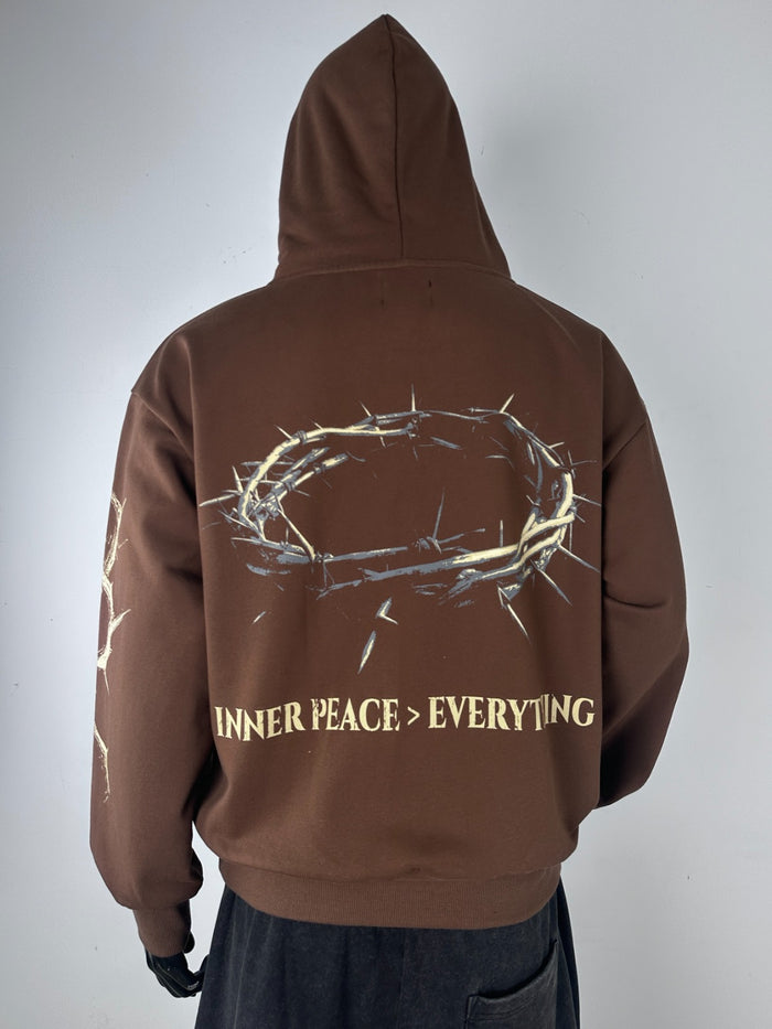 Inner Peace brown hoodie with "IP Over Everything" slogan, soft pullover hoodie featuring a relaxed fit and front pocket.