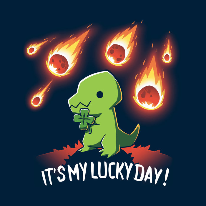 Classic Cotton T-shirt_TeeTurtle navy blue It's My Lucky Day featuring a dinosaur holding a four-leaf clover while meteors fall from the sky. The text below reads, "It's my lucky day!".