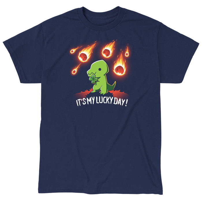 Classic Cotton T-shirt_TeeTurtle navy blue It's My Lucky Day featuring a dinosaur holding a four-leaf clover while meteors fall from the sky. The text below reads, "It's my lucky day!".
