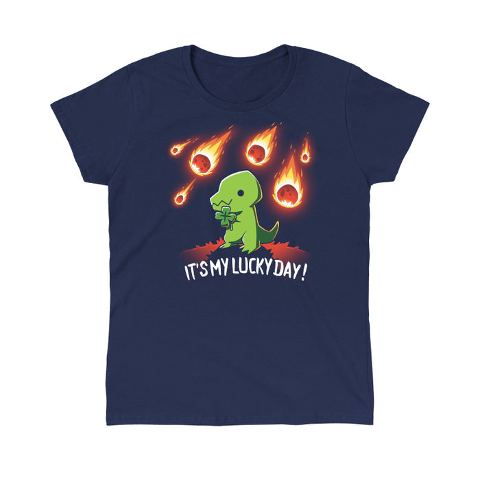 Classic Cotton T-shirt_TeeTurtle navy blue It's My Lucky Day featuring a dinosaur holding a four-leaf clover while meteors fall from the sky. The text below reads, "It's my lucky day!".