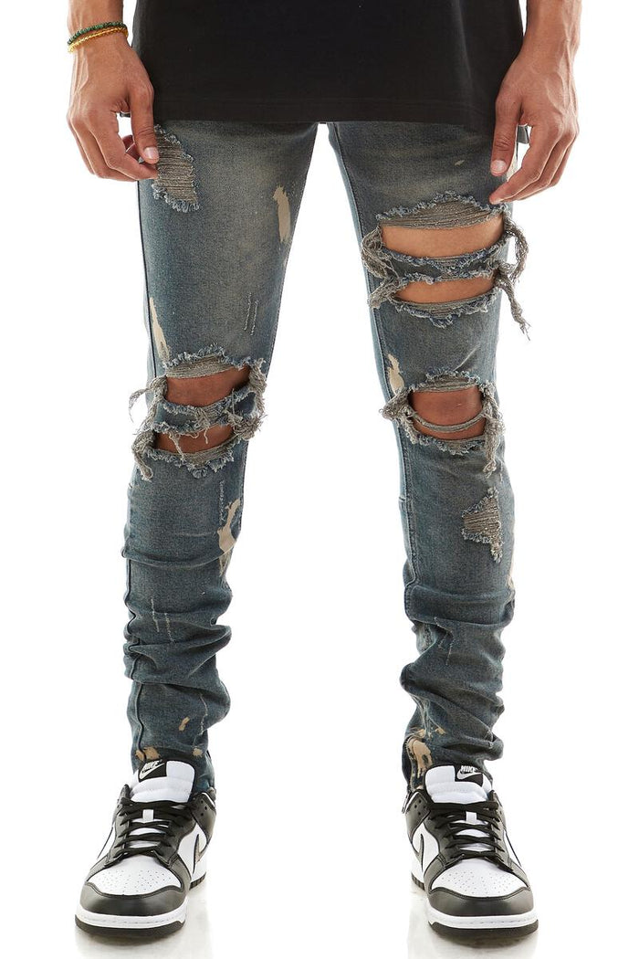 KDNK destroyed knee ankle zip denim jeans in steel blue, featuring distressed details and metal zipper accents.