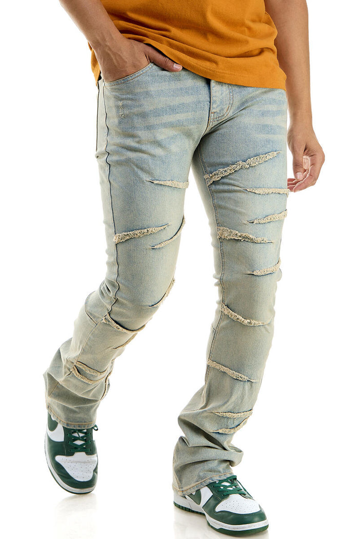 Blue KDNK Raw Edge Skinny Flare Denim jeans with distressed details and raw hem, styled on a model.