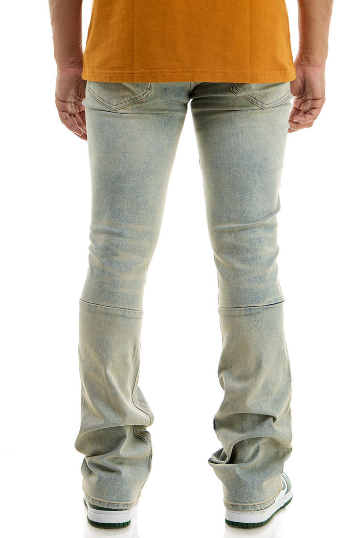 Blue KDNK Raw Edge Skinny Flare Denim jeans with distressed details and raw hem, showcasing a stylish and fitted silhouette.