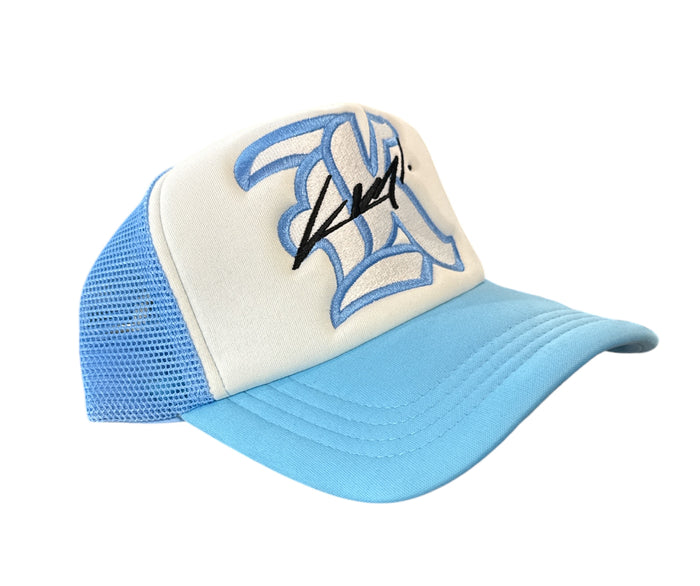 White and Carolina Blue KML ‘K’ trucker hat by KAAMIL with mesh back and adjustable strap.