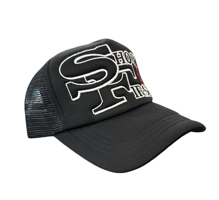 Black KML SF Trucker Hat by KAAMIL featuring mesh back and curved brim, casual streetwear accessory.