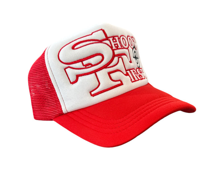 White and red KML ‘SF’ trucker hat by KAAMIL, featuring mesh back and adjustable snap closure.